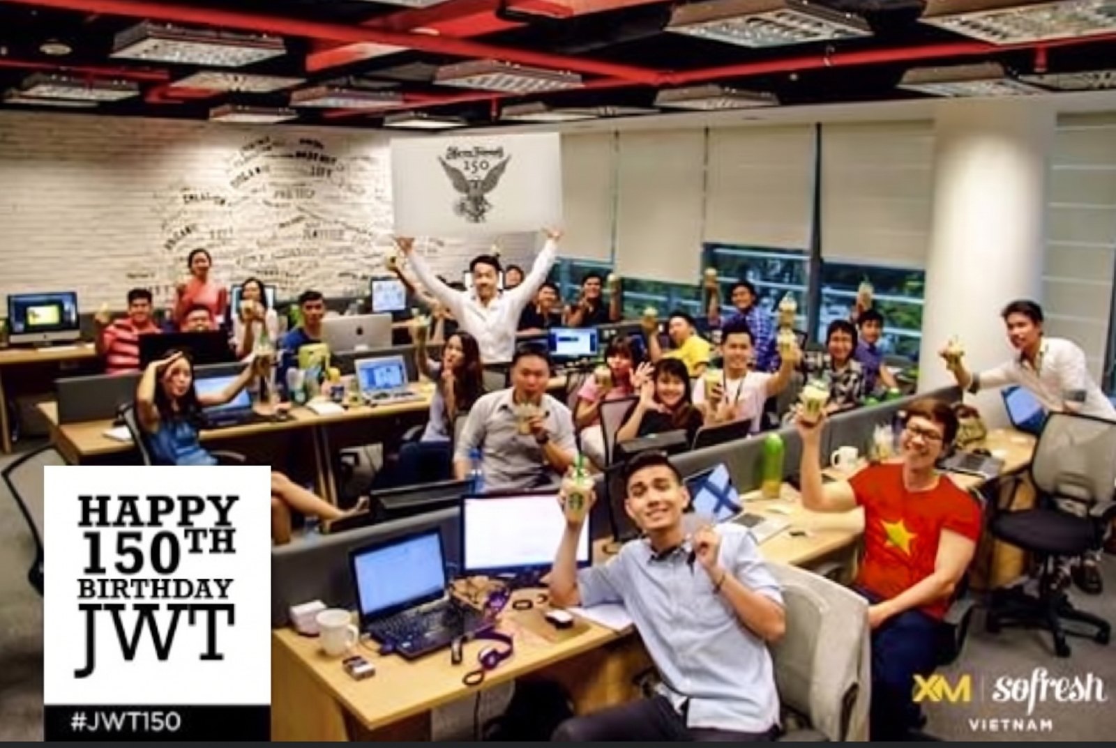 The XM Sofresh team at their desks celebrating JWT's 150th birthday