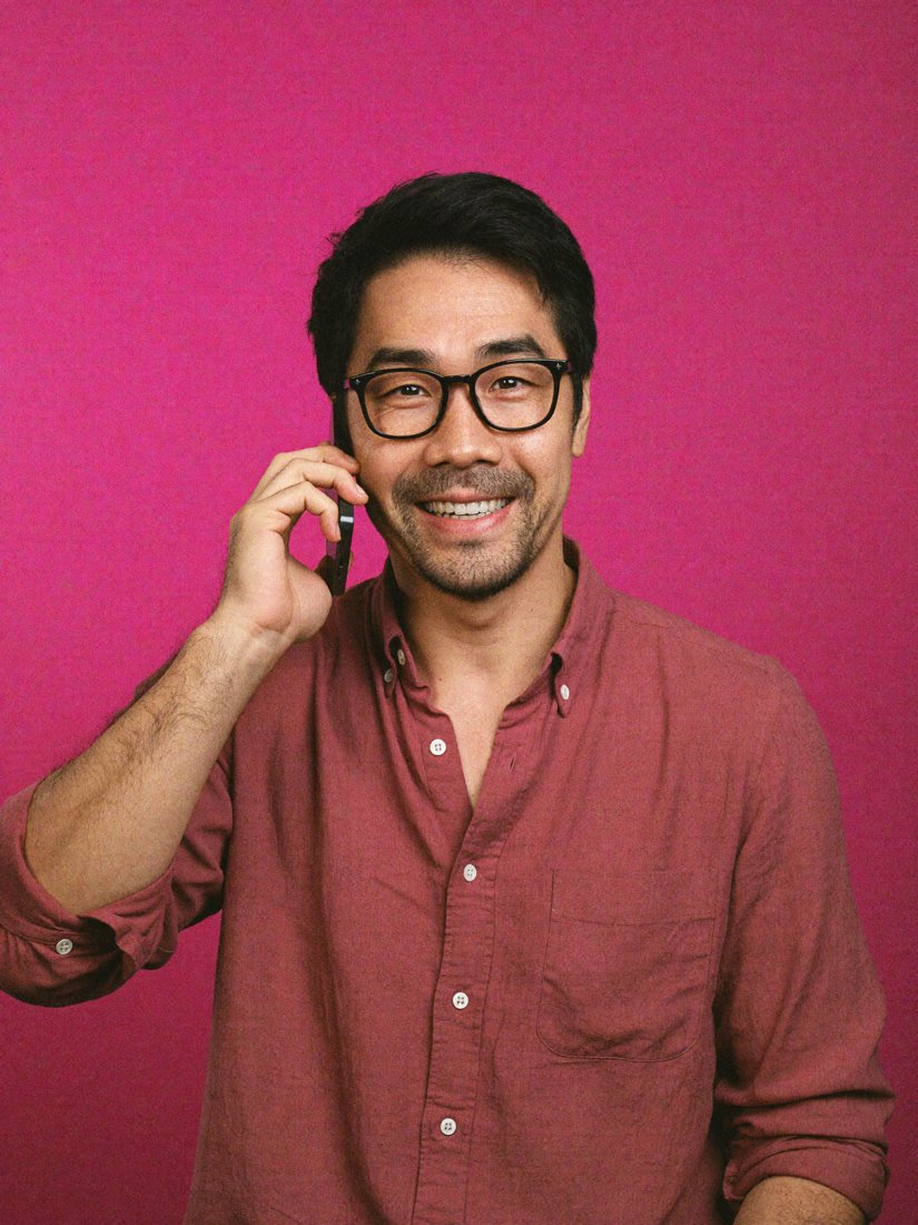 Ly on a phone call, smiling